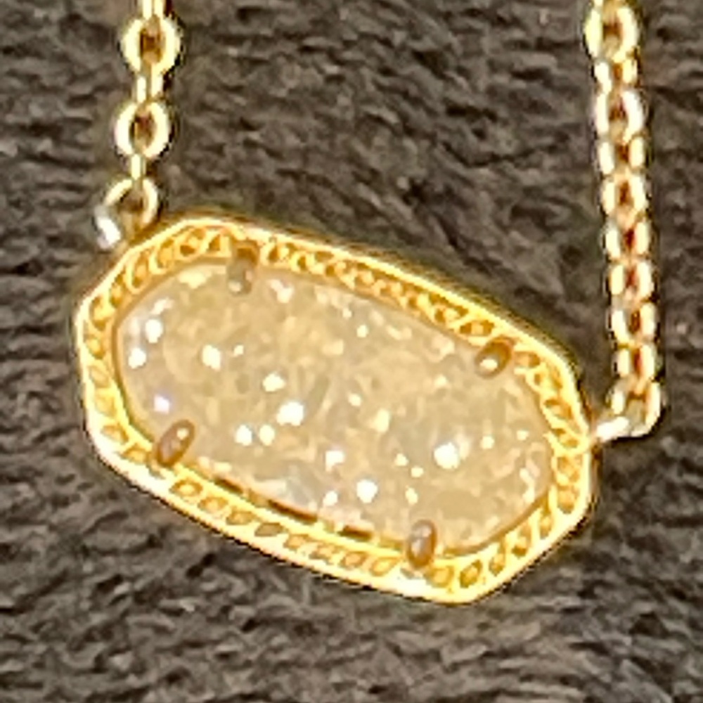 Kendra Scott gold and crushed crystal necklace.